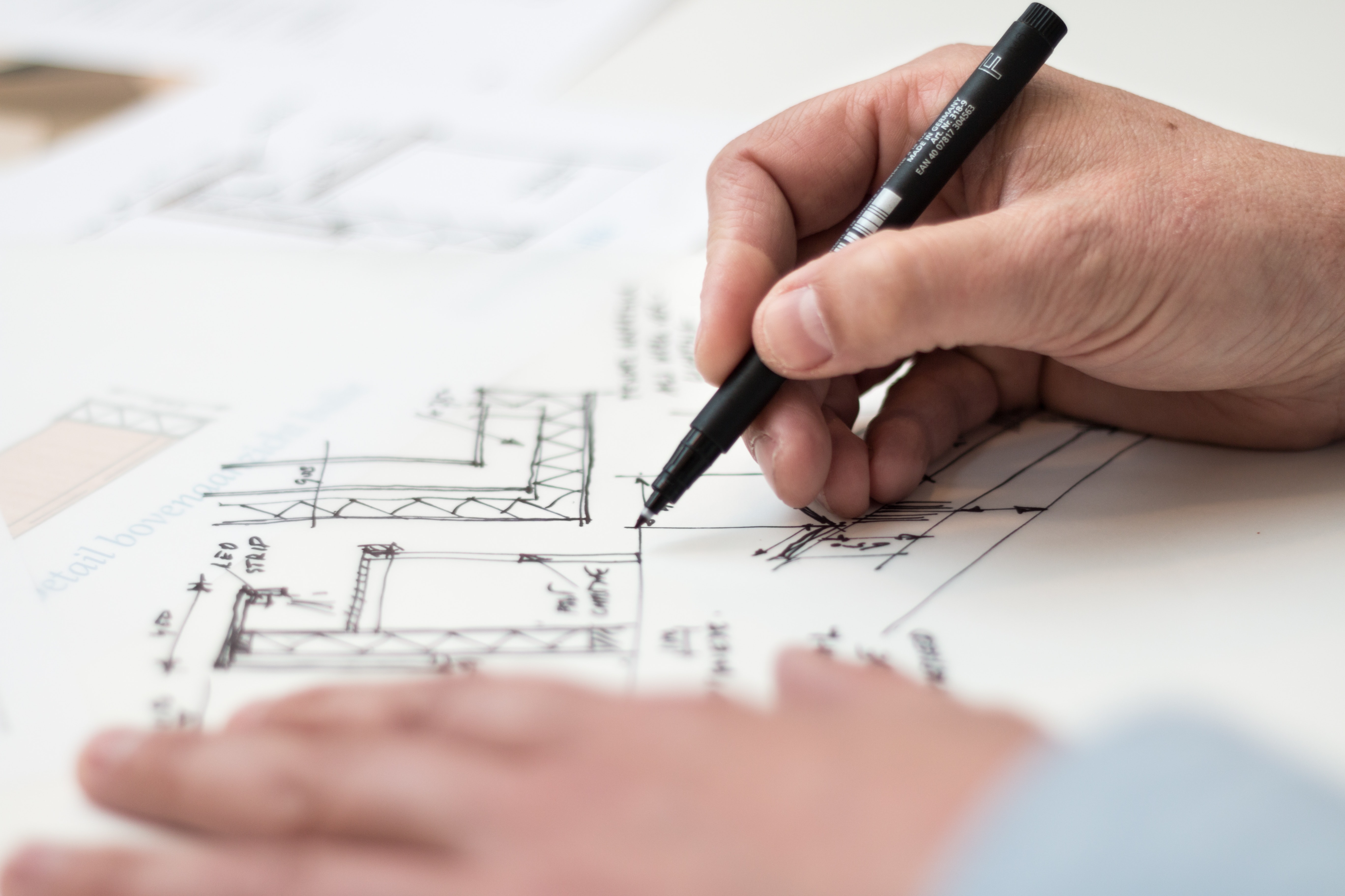 image of a person drawing building plans'